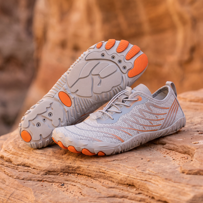 Grey Orange water trekking shoes on warm sandstone rock